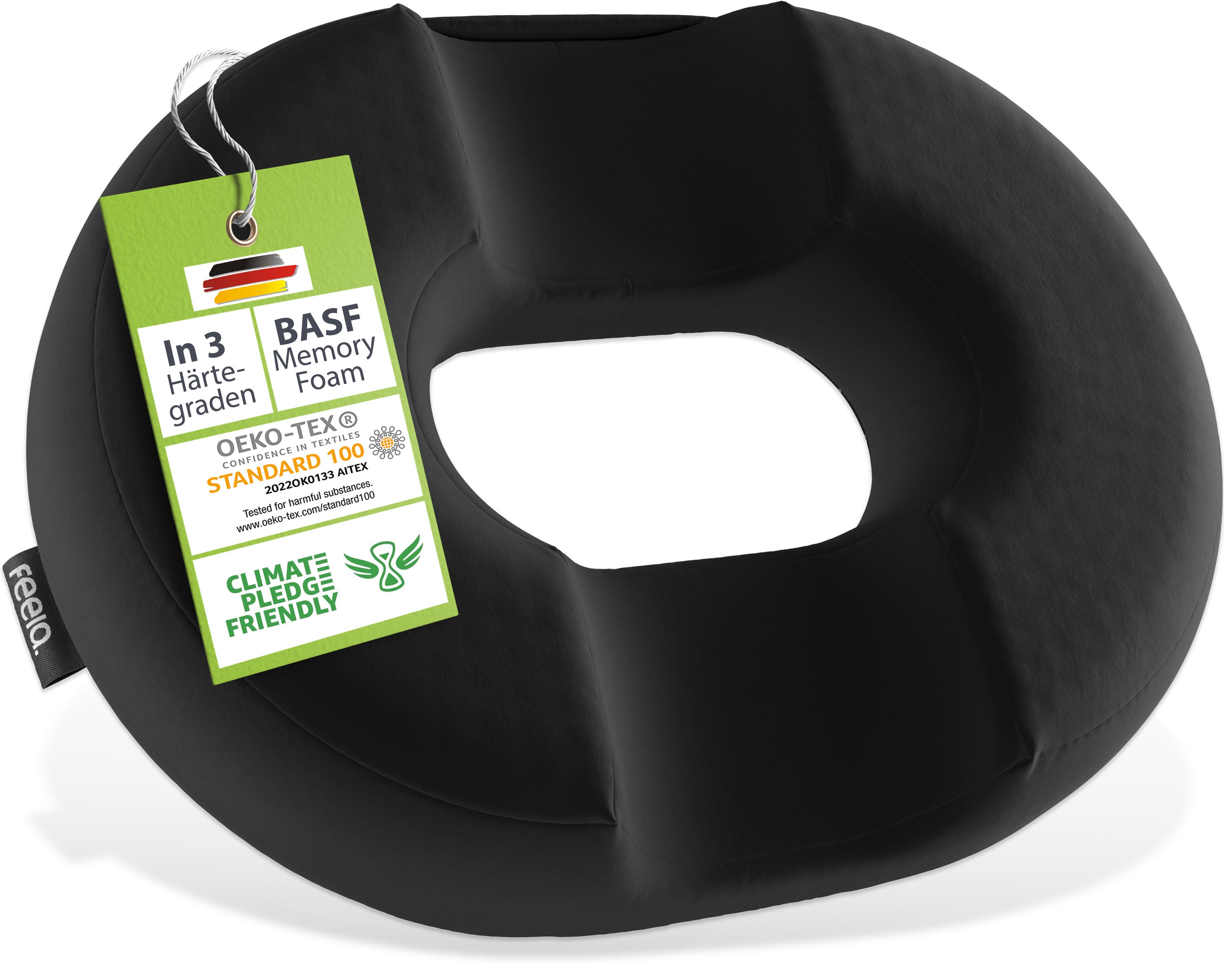 Schwarzes, orthopädisches Ringkissen von feela mit BASF Memory Foam, drei Härtegraden, OEKO-TEX® Standard 100 Zertifizierung und Klimaschutzversprechen, hängend an grüner Informationskarte.