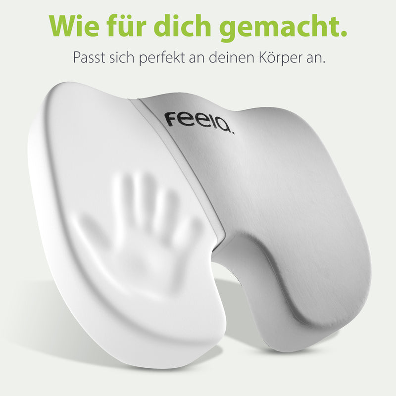 Ergonomisches Sitzkissen von feela in Silber, das sich durch Memory-Schaum perfekt an die Körperform anpasst, mit dem Slogan 'Wie für dich gemacht.'